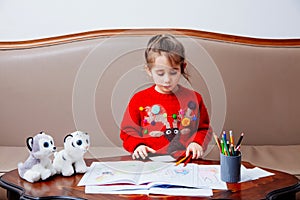 New year christmas pensil little girl writes letter Santa red jacket toy pen kid table sofa