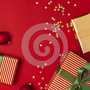 New Year Christmas presents with green ribbon, golden gift, confetti stars on red background top view. Flat lay Xmas holiday 2020