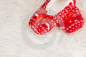 New year, Christmas slippers on white soft fur. Funny, funny, cozy photo