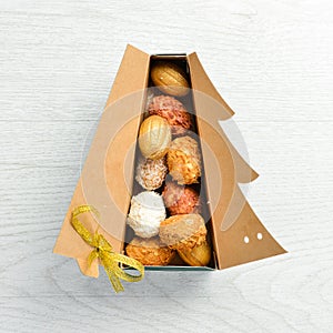 New Year and Christmas sweets. Cookies in the form of walnuts in Christmas tree-shaped boxes.