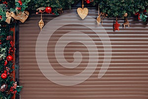 New Year and Christmas-themed backgrounds. Closed roller shutters of Christmas store for text placement