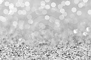 New year and Christmas. Top view of silver Glitter and white confetti lights bokeh get out of focus. abstract background