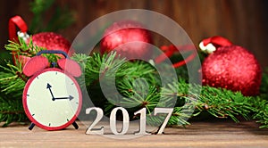 New year 2017,Christmas-tree decoration with a branch of a fir-tree and wooden figures of the coming year,