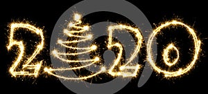 New Year 2020 with Christmas tree made by sparkler . Number 2020 and sign written sparkling sparklers . Isolated on a black