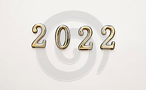 New Year and Christmas white background with golden numbers 2022. New year card decoration concept, top view with place for text