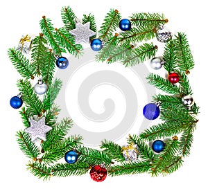 New Year and Christmas wreath decoration with green fir tree branches and blue and silver shiny xmas traditional balls and baubles