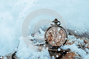 New year clock before midnight. Antique pocket watch in the snow