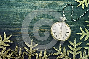 New year clock. Old pocket watch on a wooden background.