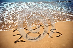 New Year 2015 is coming concept - inscription 2014 and 2015 on a beach sand