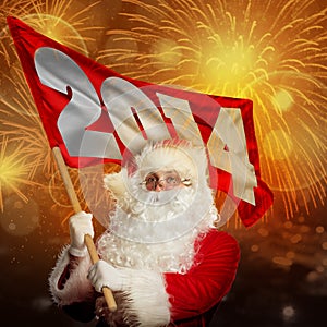 New year coming by Santa Claus. Santa with 2014 flag in firework