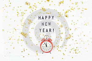 New Year composition alarm clock golden confetti