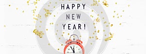 New Year composition alarm clock golden confetti