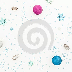 New Year composition with Christmas balls and pink confetti on white background. Flat lay, top view