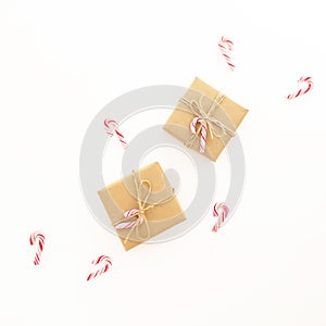 New Year composition. Christmas gifts and candy canes on white background. Flat lay, top view.