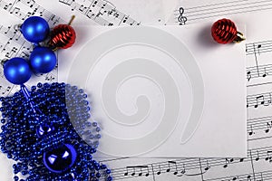 Christmas tree decorations on the table and sheet with music not