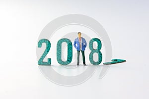 2018 New year concept business man miniature figures standing on