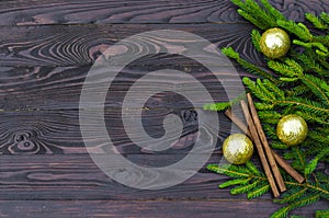 New year concept. Flat image of a Christmas tree with gold balls, Christmas decorations on a dark wooden background.