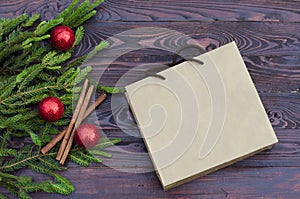 New year concept. Flat lay of a Christmas tree with red  balls, Christmas decorations, gifts on a dark wooden background.