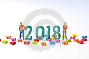 2018 New year concept man and woman miniature figures standing o