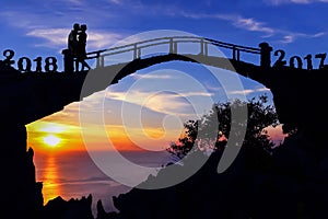 New year 2018 concept.Silhouette couple kissing on the bridge.