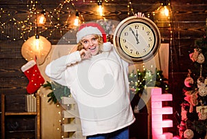 New year countdown. Merry christmas. Time for miracles. Few minutes left. Woman Santa hat hold vintage clock. Time for