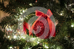 New Year decoration balls on a snowy branch. Christmas tree toy on the branches of spruce covered with snow. shiny balloon toy on