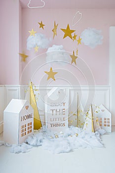 New year decoration. Tiny Christmas houses.Christmas background with white house, snowflakes, star, garlands and