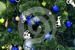 New Year decorations blue and silver balls on a faux christmas tree close up