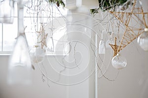 New year decorations in the form of hanging wine glasses and stars made by hand and the branch of the Christmas tree
