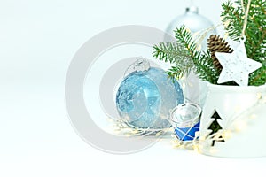 New year decorations with green christmas tree branch, glass balls and glowing garland lights