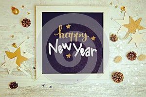 New Year decorations and objects flat lay photo with black chalkboard frame