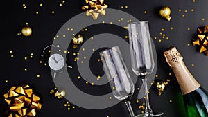 New Year Eve party celebration concept. Flat lay composition with two glasses, champagne bottle, glittering confetti and golden