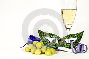 New Year Eve party favors next to glass of Champagne and grapes