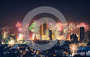 New year festival with firework display glowing over department store, illuminated building in downtown during midnight time at