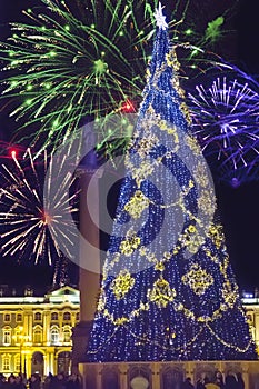 New Year fir-tree in garlands of fires at Palace Square and Christmas fireworks, St. Petersburg, Russia