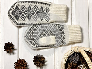 New year flat lay layouts. Knitted mittens with a pattern