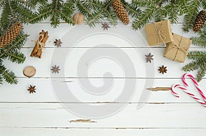 New year frame Christmas decoration on white wooden plank background. Flat lay, top view. Fir tree,pine conecinnamon