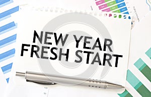 NEW YEAR FRESH START on paper sheet on charts