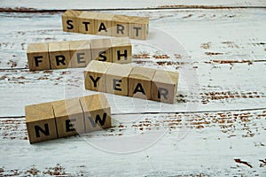 New Year Fresh Start Word alphabet letters on wooden background