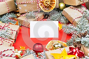 New year gift card, visitcard mockup with many presents and christmas decor on red background. Greetings template