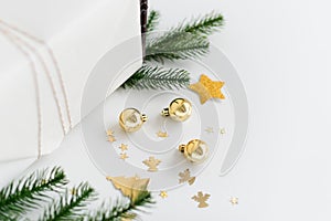 New Year gift wrapping with gold decoration. Balls, stars and tree branches. Christmas gifts, preparation for the New Year.