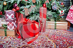 New Year gifts and present boxes under Christmas tree in holiday eve. Happy New Year and Merry Christmas