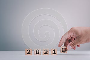 New year 2021 and goal target plan, Hand holding wood cubes with New year 2021 and goal or target icon. concept of New year Busine