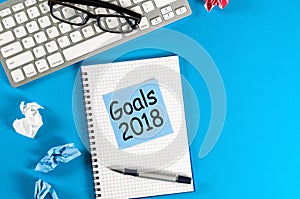 New year goal, text on notepad with office accessories. Business motivation, inspiration concepts. 2018 Goals