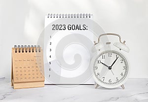 New year goals 2023, goals list with notebook and alarm clock. Resolutions, plan and goals, checklist concept. New Year