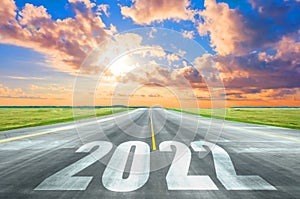 New Year 2022 Goals Concept. Empty asphalt road sunset with text 2022