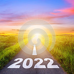 New Year 2022 Goals Concept : Empty asphalt road sunset with text go to New year 2022