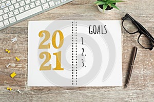 New Year goals List 2021 on wooden desk