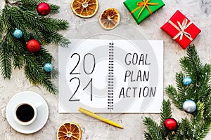 2021 New Year goals and plan with Christmas decorations and gift box. Overhead