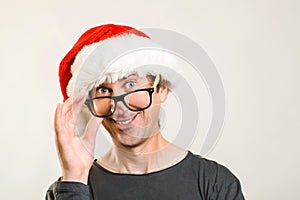 New year goals and plans. Christmas Holidays are coming. Handsome guy in Santa hat wearing glasses. Happy office worker. Christmas